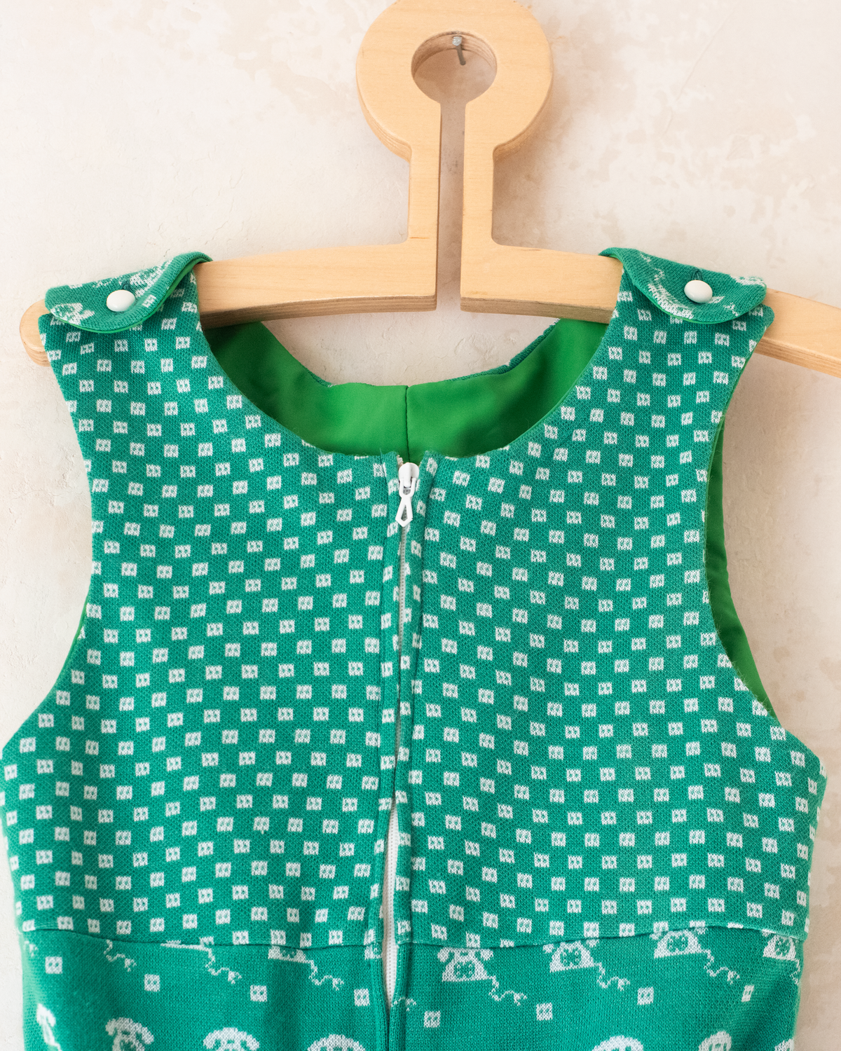 Green 70s jumpsuit with a rotary phone | 3-4 years