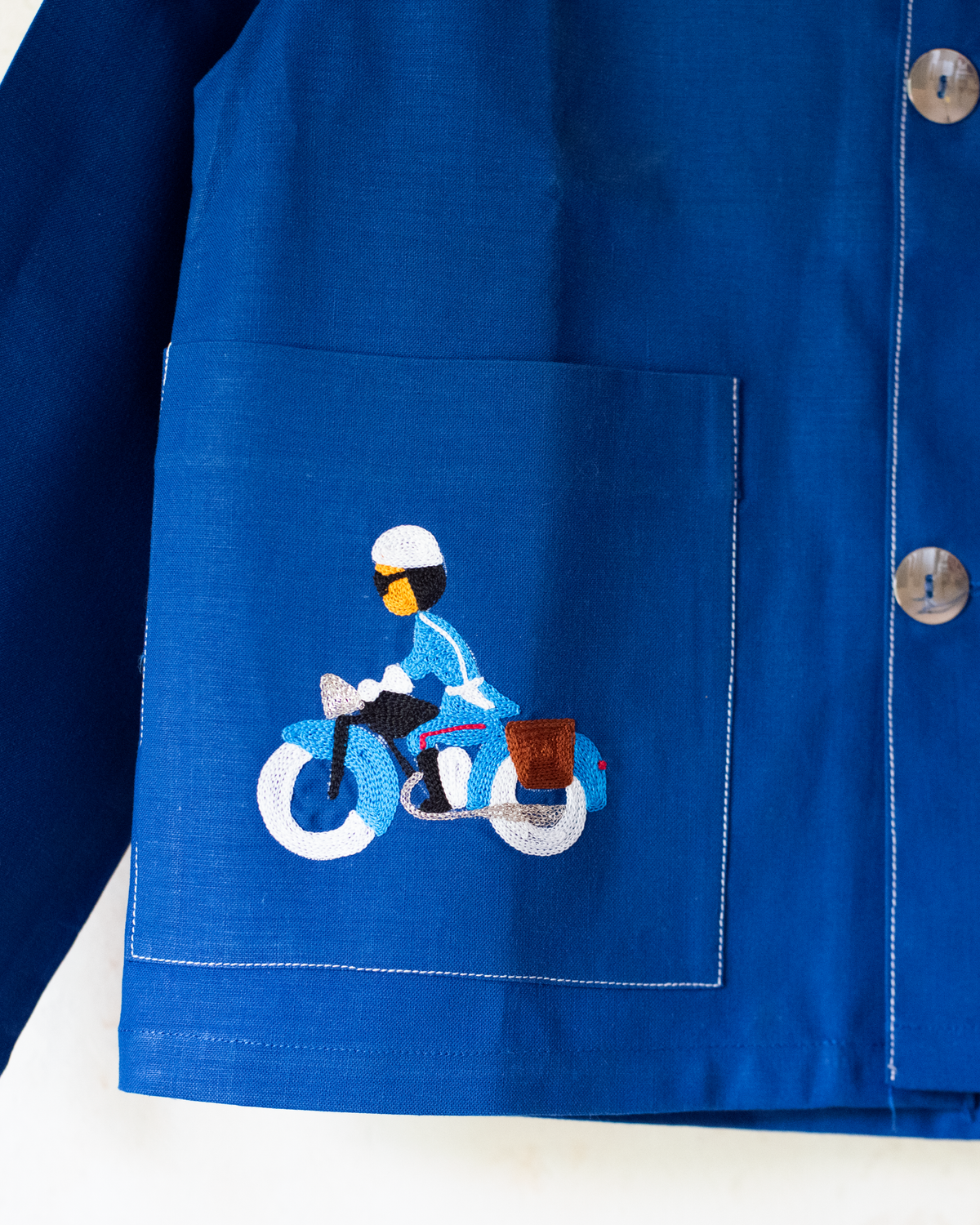 Blue shirt with embroidery of a boy riding a bicycle | French dead stock from the seventies | 4-5 years