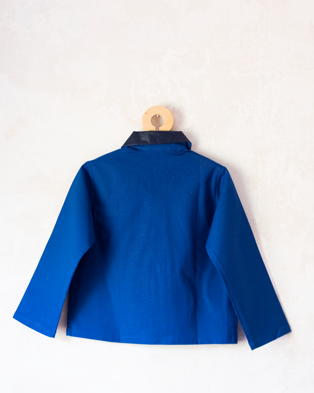 Blue shirt with embroidery of a boy riding a bicycle | French dead stock from the seventies | 4-5 years