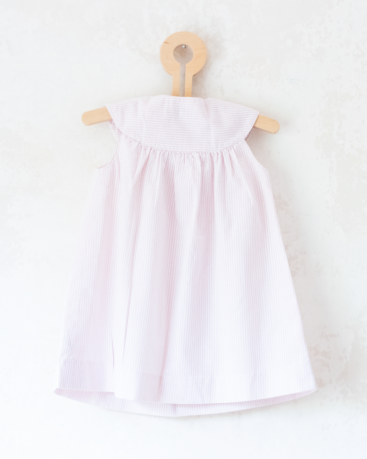 Pink and white striped dress with a goose pocket | 9-12 months