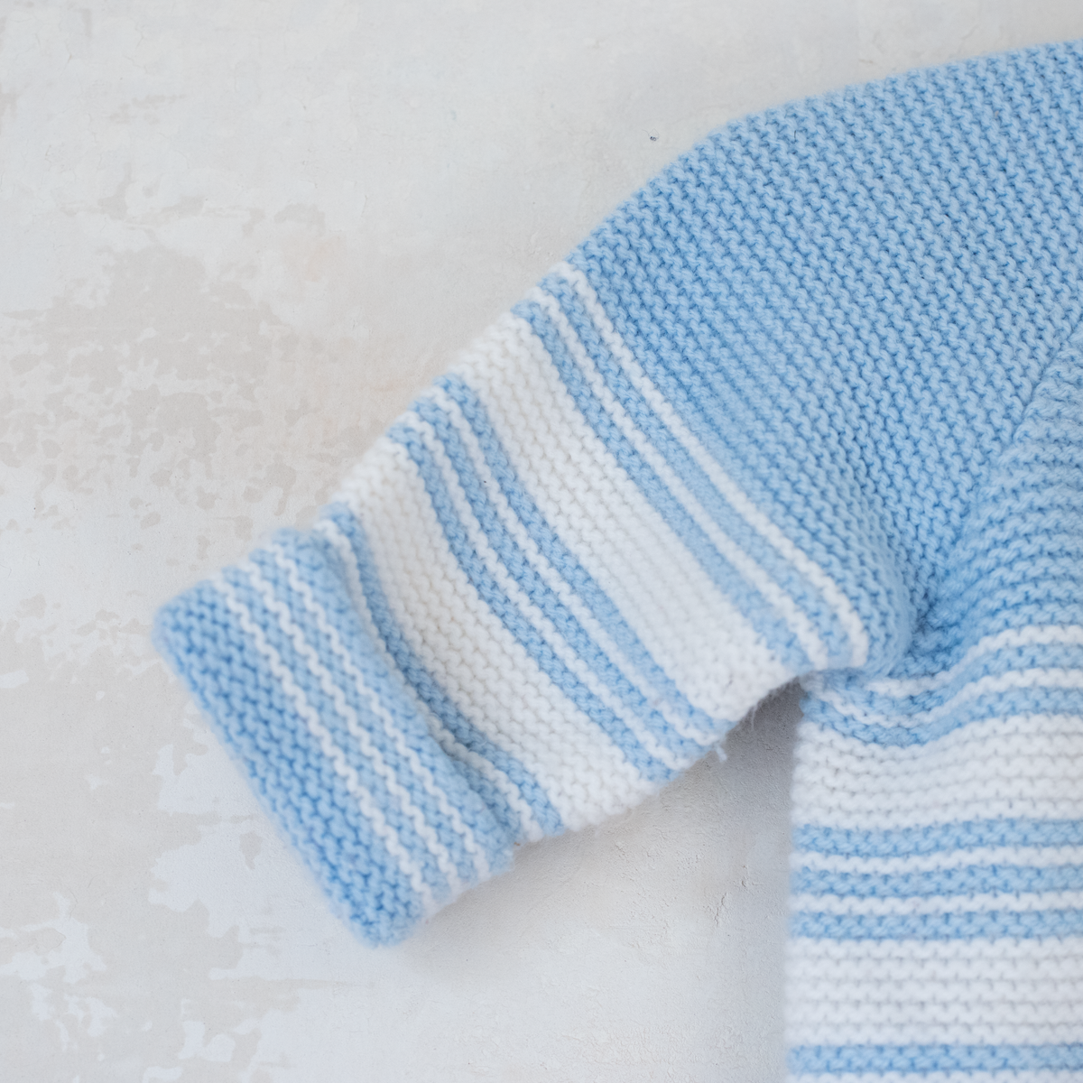 Knitted overalls in light blue and white | 6-9 months